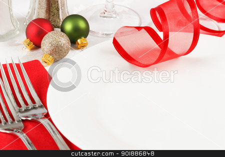 To use this stock image in your creative project, please select the size you need over to the right and click the "Add to Cart" button.
Your downloaded image will come with the Cutcaster watermark removed so don’t worry about the watermark you see on this page. Christmas Table Setting stock photo, Holiday ornaments decorate a restaurant table setting in festive red and green Christmas colors with copy space on an empty white plate by Karen Sarraga