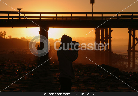 Photographer At Sunset Photographer At Sunset stock photo, Photographer at sunset sunrise near the pier by the beach and ocean. by Henrik Lehnerer