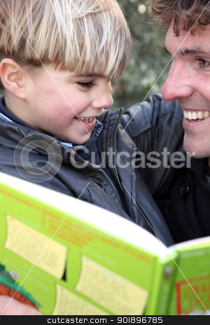 Man with little boy reading book outdoors Man with little boy reading book outdoors stock photo, Man with little boy reading book outdoors by photography33