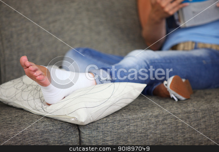 To use this stock image in your creative project, please select the size you need over to the right and click the "Add to Cart" button.
Your downloaded image will come with the Cutcaster watermark removed so don’t worry about the watermark you see on this page. Woman with sprained ankle reading on the sofa stock photo, Woman with sprained ankle reading on the sofa by photography33