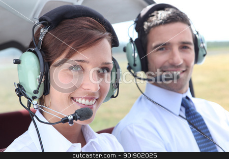 Man and woman wearing headsets in the open cockpit of a light aircraft Man and woman wearing headsets in the open cockpit of a light aircraft stock photo, Man and woman wearing headsets in the open cockpit of a light aircraft by photography33