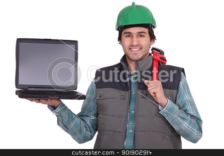 A manual worker holding a laptop A manual worker holding a laptop stock photo, A manual worker holding a laptop by photography33