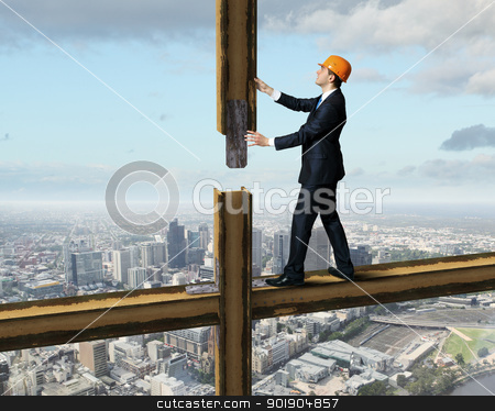 Businessman standing on the construction site Businessman standing on the construction site stock photo, Businessman standing in suit on the construction site by Sergey Nivens