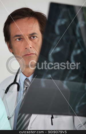 Doctor looking at X-ray Doctor looking at X-ray stock photo, Doctor looking at X-ray by photography33