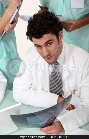 To use this stock image in your creative project, please select the size you need over to the right and click the "Add to Cart" button.
Your downloaded image will come with the Cutcaster watermark removed so don’t worry about the watermark you see on this page. Three hospital workers gathered around x-ray image stock photo, Three hospital workers gathered around x-ray image by photography33
