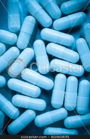 Pills Pills stock photo, Macro view of pills on blue lit. by Homydesign