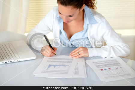 To use this stock image in your creative project, please select the size you need over to the right and click the "Add to Cart" button.
Your downloaded image will come with the Cutcaster watermark removed so don’t worry about the watermark you see on this page. Charming businesswoman reading documents stock photo, Charming businesswoman reading documents at workplace in front of her laptop by pablocalvog