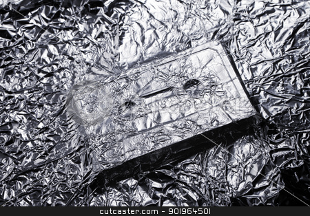 To use this stock image in your creative project, please select the size you need over to the right and click the "Add to Cart" button.
Your downloaded image will come with the Cutcaster watermark removed so don’t worry about the watermark you see on this page. Audio stock photo, Audio compact cassette covered with aluminium foil. by Stocksnapper