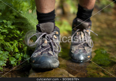 Hicking shoes in outdoor action Hicking shoes in outdoor action stock photo, Closeup of hiking shoes with a stream in the background by kamsta