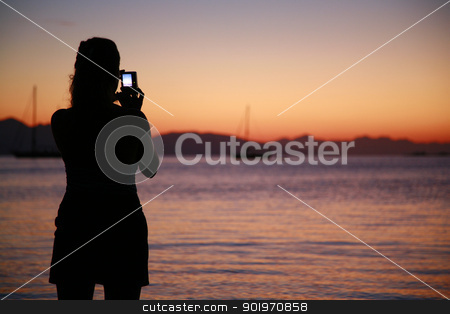 Girl is taking picture of beatiful sunset Girl is taking picture of beatiful sunset stock photo, Sunset in Datca with sailboats by necati turker