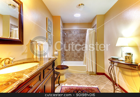 Golden nice bathroom with brown tiles and wood cabinet. Golden nice bathroom with brown tiles and wood cabinet. stock photo, Golden nice bathroom with brown ceramic tiles and wood cabinet. by iriana88w