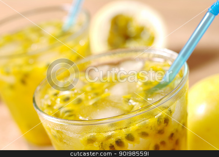 Passion Fruit Juice Passion Fruit Juice stock photo, Passion-fruit juice with icecubes and blue drinking straws with passion-fruits in the background on wood (Selective Focus, Focus on the front of the glass) by Ildiko Papp