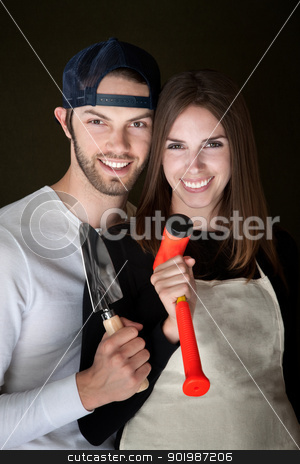 Happy Couple Happy Couple stock photo, Happy Caucasian couple holding hand tools by Scott Griessel