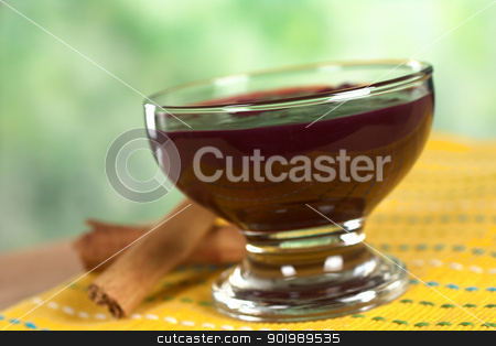 Peruvian Dessert Called Mazamorra Morada Peruvian Dessert Called Mazamorra Morada stock photo, Popular Peruvian dessert called Mazamorra Morada (made out of purple corn) with cinnamon sticks on the side (Selective Focus, Focus on the front of the bowl) by Ildiko Papp