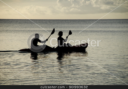 Kayakers silhouetted on the ocean Kayakers silhouetted on the ocean stock photo, Man and woman silhouetted at sea in a kayak by Sarah Marchant