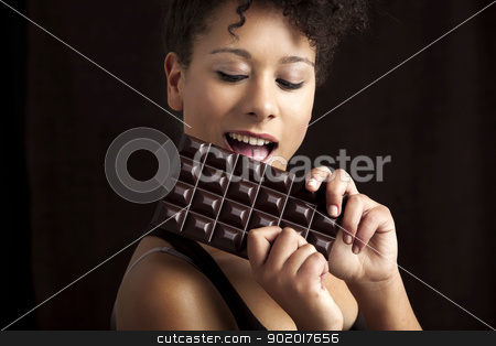 To use this stock image in your creative project, please select the size you need over to the right and click the "Add to Cart" button.
Your downloaded image will come with the Cutcaster watermark removed so don’t worry about the watermark you see on this page. Woman eating chcolate stock photo, Beautiful african woman holding and eating a huge dark chocolate bar by ikostudio