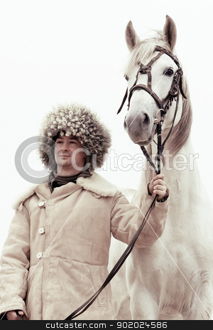 To use this stock image in your creative project, please select the size you need over to the right and click the "Add to Cart" button.
Your downloaded image will come with the Cutcaster watermark removed so don’t worry about the watermark you see on this page. Man and horse stock photo, Man wearing papakhi and his horse - Tersk stallion by Yulia Chupina