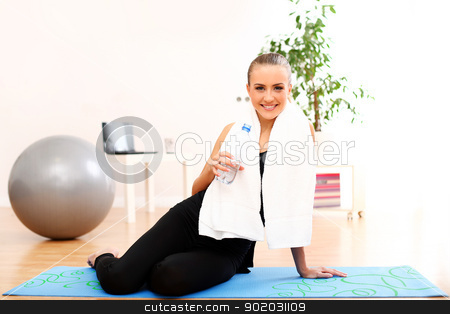 To use this stock image in your creative project, please select the size you need over to the right and click the "Add to Cart" button.
Your downloaded image will come with the Cutcaster watermark removed so don’t worry about the watermark you see on this page. Girl with towel drink water after fitness training stock photo, Closeup of girl with towel drinking water after fitness training at home by yekostock