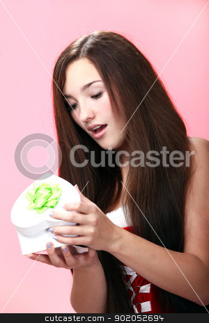 To use this stock image in your creative project, please select the size you need over to the right and click the "Add to Cart" button.
Your downloaded image will come with the Cutcaster watermark removed so don’t worry about the watermark you see on this page. Beautiful christmas girl in red with gift stock photo, Portrait of young and beautiful christmas girl in red with gift by yekostock