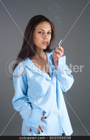 To use this stock image in your creative project, please select the size you need over to the right and click the "Add to Cart" button.
Your downloaded image will come with the Cutcaster watermark removed so don’t worry about the watermark you see on this page. beautiful young brunette woman with cigarette stock photo, Attractive brunette girl with cigarette at grey background by Aikon