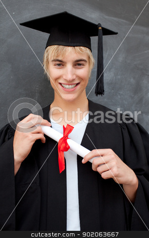 Portrait of teen Guy Celebrating Graduation Portrait of teen Guy Celebrating Graduation stock photo, Portrait of teen Guy Celebrating Graduation in the class by Wavebreak Media