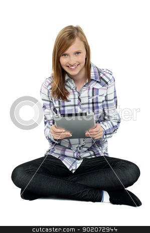 To use this stock image in your creative project, please select the size you need over to the right and click the "Add to Cart" button.
Your downloaded image will come with the Cutcaster watermark removed so don’t worry about the watermark you see on this page. Smartly dressed teenager surfing on tablet pc stock photo, Smartly dressed teenager surfing on tablet pc. Sitting with legs crossed on studio floor. by Ishay Botbol