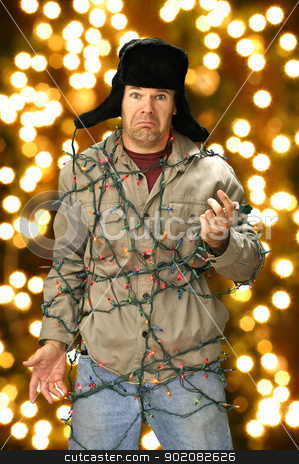 To use this stock image in your creative project, please select the size you need over to the right and click the "Add to Cart" button.
Your downloaded image will come with the Cutcaster watermark removed so don’t worry about the watermark you see on this page. Christmas lights stock photo, Funny confused man wrapped in colorful Christmas lights by Chad Zuber