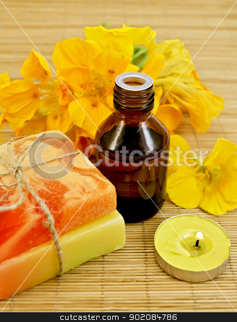 To use this stock image in your creative project, please select the size you need over to the right and click the "Add to Cart" button.
Your downloaded image will come with the Cutcaster watermark removed so don’t worry about the watermark you see on this page. Oil with nasturtiums and candle stock photo, Oil in a bottle, two homemade soaps, nasturtium flowers, yellow candle on a bamboo mat by rezkrr