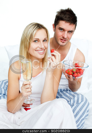To use this stock image in your creative project, please select the size you need over to the right and click the "Add to Cart" button.
Your downloaded image will come with the Cutcaster watermark removed so don’t worry about the watermark you see on this page. Couple celebrating an engagement with strawberries and champagne stock photo, Couple celebrating an engagement with strawberries and champagne in bed by Wavebreak Media
