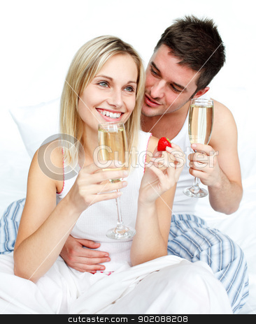 To use this stock image in your creative project, please select the size you need over to the right and click the "Add to Cart" button.
Your downloaded image will come with the Cutcaster watermark removed so don’t worry about the watermark you see on this page. Young lovers eating strawberries and drinking champagne stock photo, Young lovers eating strawberries and drinking champagne in bed by Wavebreak Media