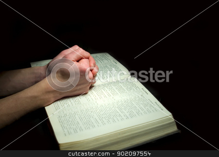 bible bible stock photo, A mans hands clasped in prayer over a Bible by Vitaliy Pakhnyushchyy