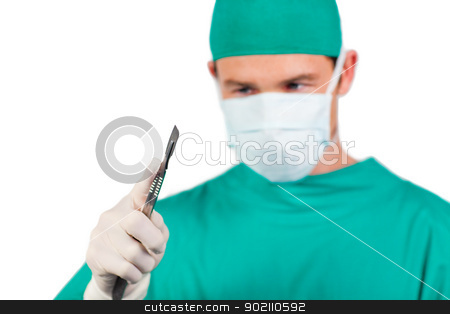 Self-assured surgeon holding a scalpel Self-assured surgeon holding a scalpel stock photo, Self-assured surgeon holding a scalpel isolated on a white background by Wavebreak Media