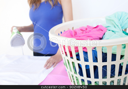Close-up of a woman ironing Close-up of a woman ironing stock photo, Close-up of a woman ironing against a white background by Wavebreak Media