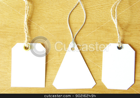 Paper tag paper tag stock photo, paper tag isolated on a wooden background by Vitaliy Pakhnyushchyy