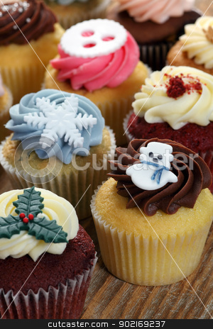 To use this stock image in your creative project, please select the size you need over to the right and click the "Add to Cart" button.
Your downloaded image will come with the Cutcaster watermark removed so don’t worry about the watermark you see on this page. Christmas cupcakes stock photo, Photo of many cupcakes decorated for Christmas. Focus on snowman. by © Ron Sumners