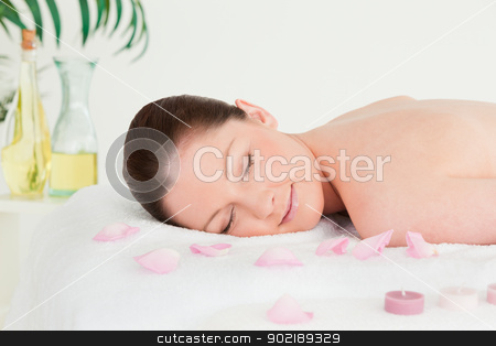 To use this stock image in your creative project, please select the size you need over to the right and click the "Add to Cart" button.
Your downloaded image will come with the Cutcaster watermark removed so don’t worry about the watermark you see on this page. Beautiful woman lying on a massage table with petals and unlight stock photo, Beautiful woman lying on a massage table with petals and unlighted candles by Wavebreak Media