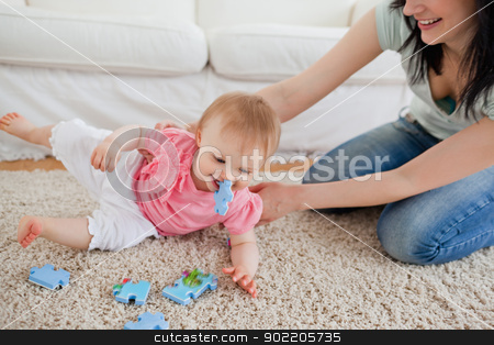 To use this stock image in your creative project, please select the size you need over to the right and click the "Add to Cart" button.
Your downloaded image will come with the Cutcaster watermark removed so don’t worry about the watermark you see on this page. Lovely woman and her baby playing with puzzle pieces while sitti stock photo, Lovely woman and her baby playing with puzzle pieces while sitting on a carpet in the living room by Wavebreak Media