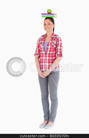 To use this stock image in your creative project, please select the size you need over to the right and click the "Add to Cart" button.
Your downloaded image will come with the Cutcaster watermark removed so don’t worry about the watermark you see on this page. Charming female holding an apple and books on her head while sta stock photo, Charming female holding an apple and books on her head while standing against a white background by Wavebreak Media