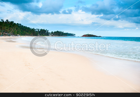 Tropical beach with cloudy dark blue sky Tropical beach with cloudy dark blue sky stock photo, Tropical beach with cloudy dark blue sky and footprint on yellow sand by Iryna Rasko