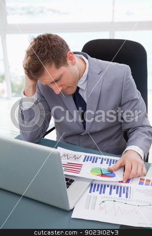 To use this stock image in your creative project, please select the size you need over to the right and click the "Add to Cart" button.
Your downloaded image will come with the Cutcaster watermark removed so don’t worry about the watermark you see on this page. Businessman frustrated by market research results stock photo, Businessman at his desk frustrated by market research results by Wavebreak Media