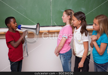To use this stock image in your creative project, please select the size you need over to the right and click the "Add to Cart" button.
Your downloaded image will come with the Cutcaster watermark removed so don’t worry about the watermark you see on this page. Schoolboy yelling through a megaphone to his classmates stock photo, Schoolboy yelling through a megaphone to his classmates in a classroom by Wavebreak Media