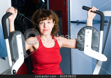To use this stock image in your creative project, please select the size you need over to the right and click the "Add to Cart" button.
Your downloaded image will come with the Cutcaster watermark removed so don’t worry about the watermark you see on this page. Training girl stock photo, Young woman on training apparatus in fitness center by Aikon