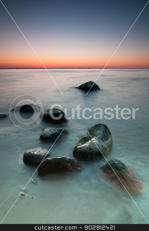 To use this stock image in your creative project, please select the size you need over to the right and click the "Add to Cart" button.
Your downloaded image will come with the Cutcaster watermark removed so don’t worry about the watermark you see on this page. Seascape Sunset stock photo, Sunset scenic view over Baltic Sea with stones in foreground. Long exposure. by Tiramisu Studio