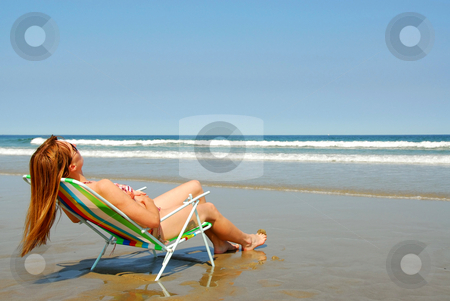 To use this stock image in your creative project, please select the size you need over to the right and click the "Add to Cart" button.
Your downloaded image will come with the Cutcaster watermark removed so don’t worry about the watermark you see on this page. Woman relaxing on beach stock photo, Young woman relaxing in a beach chair on the ocean shore by Elena Elisseeva