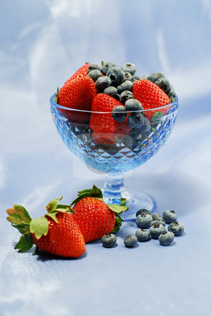 Berry still life Berry still life stock photo, Strawberries and blueberries in blue glass bowl on blue background by Elena Elisseeva