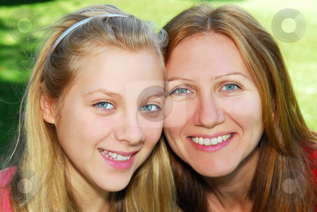 To use this stock image in your creative project, please select the size you need over to the right and click the "Add to Cart" button.
Your downloaded image will come with the Cutcaster watermark removed so don’t worry about the watermark you see on this page. Mother and daughter stock photo, Portrait of a smiling mother and teenage daughter in summer park by Elena Elisseeva