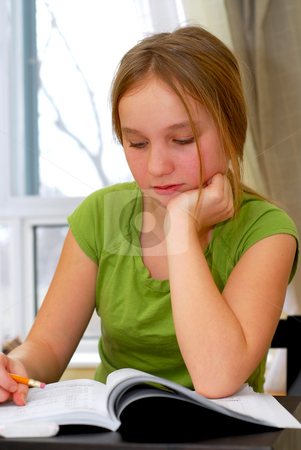 School girl stock photo Young school girl doing homework at her desk by