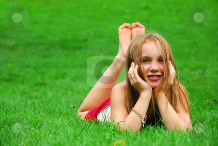 Young girl grass Young girl grass stock photo, Young girl lying on green grass in the summer by Elena Elisseeva