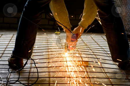 Construction worker with Angle Grinder Construction worker with Angle Grinder stock photo, Construction worker cutting a construction net with an Angle grinder by Claudia Van Dijk
