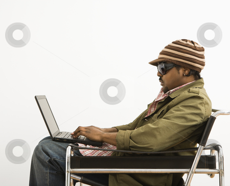 To use this stock image in your creative project, please select the size you need over to the right and click the "Add to Cart" button.
Your downloaded image will come with the Cutcaster watermark removed so don’t worry about the watermark you see on this page. Man on laptop. stock photo, Side view of African-American mid-adult man wearing hat and typing on laptop computer. by Iofoto Images